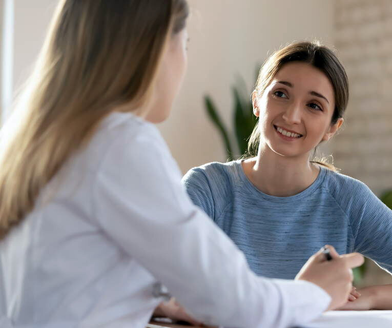 Picture of a teenage girl talking with a behavioral healthcare professional